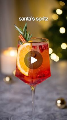 a glass filled with liquid and garnished with an orange slice