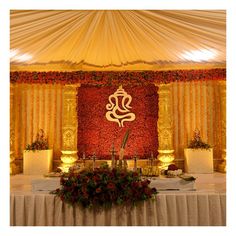 an image of a decorated stage with flowers and candles on the table in front of it