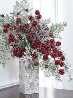 a vase filled with red flowers on top of a table