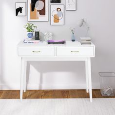 a white table with some pictures on the wall