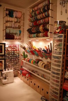 a room filled with lots of different types of thread and spools on shelves