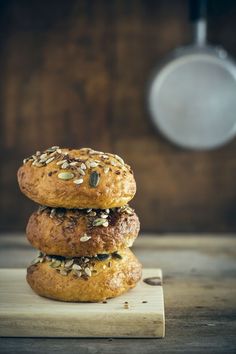 three sesame seed bagels stacked on top of each other