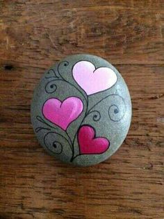 a rock with hearts painted on it