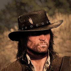 a man with long hair wearing a black hat and brown vest is looking at the camera