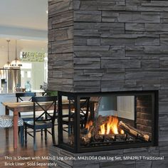 a fire place in the middle of a living room next to a dining room table