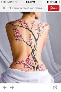 the back of a woman's body with flowers on it and an arrow in the middle