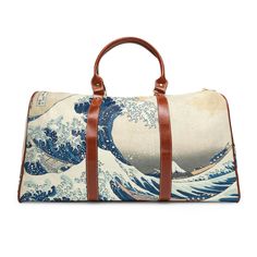 Introducing our stunning Great Wave travel bag, a stylish and durable companion for all your adventures. Made with high-grade waterproof fabric, this personalized travel bag is designed to keep your essentials safe and secure no matter where you go. Featuring the iconic Great Wave painting, this travel bag is a true work of art. The all-over print captures the vivid colors and intricate details of the original painting, from the crashing waves to the graceful swirls of the water. With multiple compartments, a resilient carrying handle, and an adjustable shoulder strap, this travel bag is designed for convenience and comfort. The brown PU leather handles and gold-colored zipper add a touch of luxury to the design, while the polyester lining ensures that your belongings stay safe and dry. At White Waterproof Travel Bag, Waterproof White Travel Bag, Rectangular Travel Accessories With Removable Pouch For Overnight Trips, Blue Waterproof Rectangular Travel Bag, Waterproof Rectangular Travel Accessories, Rectangular Travel Bag With Luggage Sleeve For Outdoor, Waterproof Rectangular Duffle Bag For Overnight Trips, Waterproof Duffle Bag For Overnight Trips, White Rectangular Travel Bag For Overnight Trips