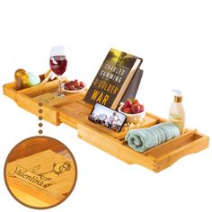 two wooden trays with food and wine on them, one holding a book while the other holds a glass of wine