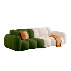 a green and white couch sitting on top of a white floor next to a pillow