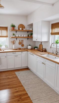 a kitchen with white cabinets and wooden counter tops, an area rug on the floor