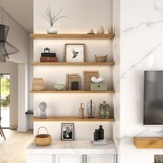 a living room filled with furniture and a flat screen tv on top of a wooden shelf