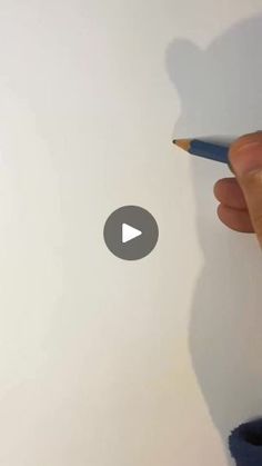 someone is drawing on paper with a pencil