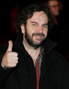 a bearded man giving the thumbs up sign