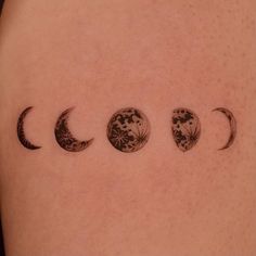 a woman's back with three phases of the moon tattoo