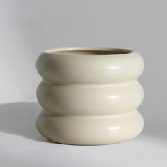 a white vase sitting on top of a table