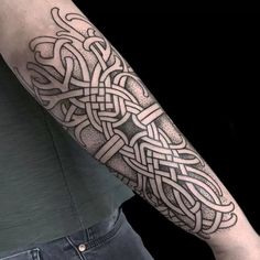 a man's arm with an intricate tattoo design on the left forearm and shoulder