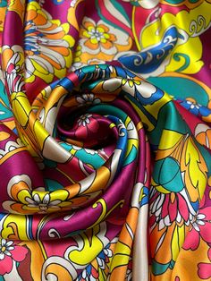 an image of colorful fabric with flowers on it