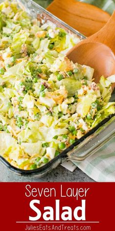 a casserole dish filled with vegetables and topped with a wooden spoon