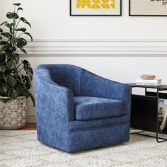 a blue chair sitting next to a table with a potted plant on top of it