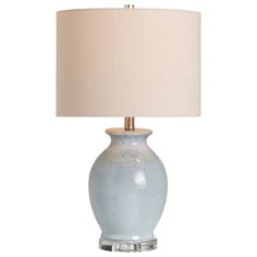 a light blue table lamp with a white shade