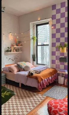 a bedroom with purple and white checkered walls