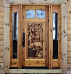 a wooden door with carvings on the front and side panels, in front of a log cabin