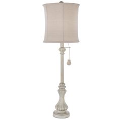 a white lamp with a beige shade on it