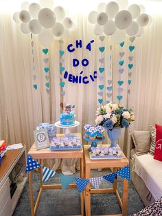 two tables with desserts on them in front of balloons