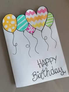 a birthday card with balloons and the words happy birthday written in black ink on white paper