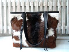 "BROWN COWHIDE BAGS, Cowhide Shoulder Bag, Cowhide Tote Bag, Cowhide on Hair Bags, Cowhide Weekender Bag, Brown Tote Bag, Cowfur Brown Bag.  This bucket bag will serve you perfectly, easy to locate all your needs; from work files & samples to clothes & snacks. I use mine everyday to carry all my big files, samples, laptop and more! Lining Cotton Drill. Inside 1 zip compartment w 2 open pockets opposite side . Size Cm : Length 48.2 cm X High 28.5 cm X Wide 11,5 cm X Shoulder Strap 64cm  Size Inch Hair Bags, Western Tote Bags, Office Documents, Cowhide Purse, Document Bag, Market Tote Bag, Brown Tote Bag, Cowhide Bag, Brown Cowhide