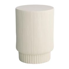 a white vase sitting on top of a table