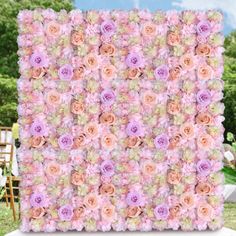 an artificial flower wall in the shape of a square with pink and white flowers on it