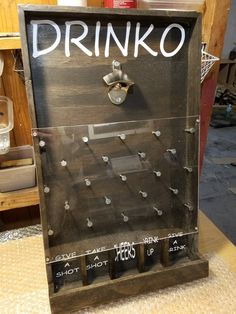 a drink dispenser sitting on top of a table next to a bottle opener