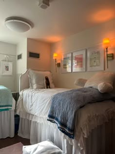 a bedroom with two beds and pictures on the wall