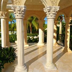 two white pillars in the middle of a courtyard