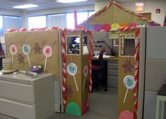 an office cubicle decorated like a gingerbread house and candy canes on the door