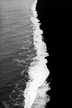 black and white photograph of waves coming in from the ocean