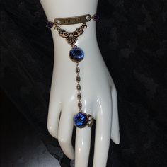 One Of A Kind & Made By Hand Slave Bracelet Original Design Beautiful Swarovski Purple & Blue Gemstones "Dream" Plate Bracelet Comes To A Drop And Leads To A Matching Gem Ring (Adjustable Ring) Beautiful Bronze Chain Of Scrolled Oval Rings 2 More Matching Color Diamond Shaped Gemstones On Each Side Of The "Dream" Curved Plate On Adjustable Matching Chain Artist: L.A.Rush Dark Blue Rings, Bracelet Original, Gem Ring, Oval Rings, Blue Gems, Diamond Shaped, Blue Gemstones, Blue Bracelet, Blue Rings