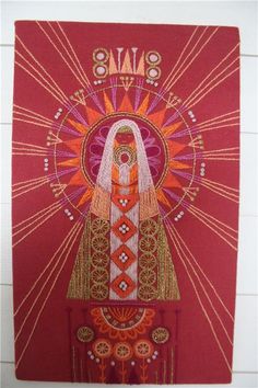 an image of the virgin mary in red and gold