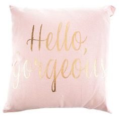 a pink and gold pillow with the words hello gorgeous written in cursive font