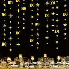 the table is set for a party with gold stars and confetti on it