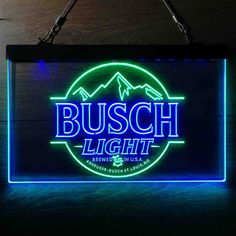 the busch light neon sign is hanging on a wall