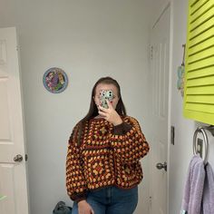 a woman taking a selfie in the bathroom with her cell phone up to her face