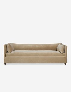 a beige couch sitting on top of a white floor