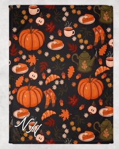 an orange and black fall themed scarf with pumpkins, leaves, and teapots