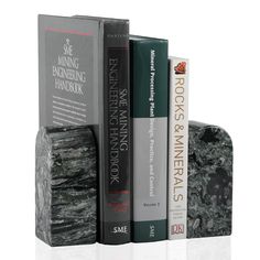 three books are stacked on top of each other in the shape of a bookend