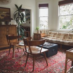 a living room filled with furniture and lots of windows