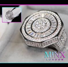 a close up of a ring with diamonds on it's side and an image of the