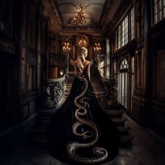 a woman in a long black dress with a snake on it's tail is walking down the stairs