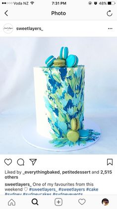 the cake is decorated with blue and green icing on it's top layer